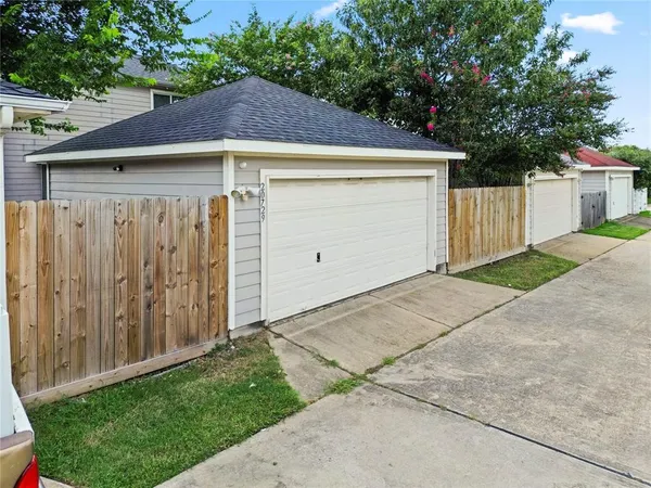 a view of small house with a garage