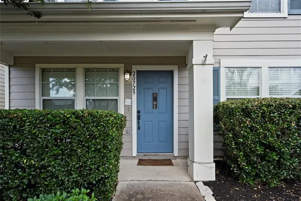 front view of a house with a potted plant