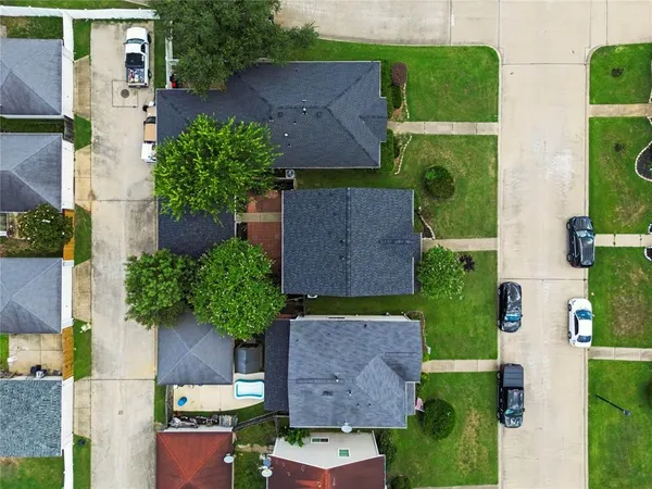 an aerial view of a house with garden space and street view