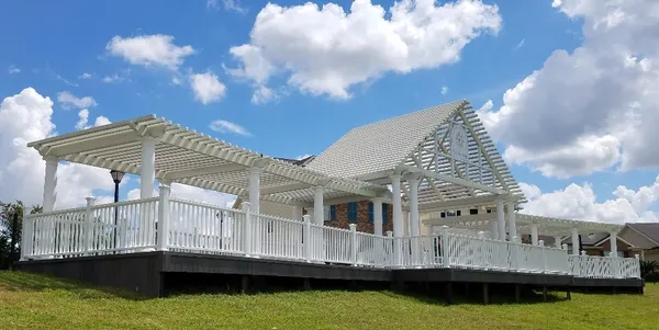 a view of a house with yard and sitting area