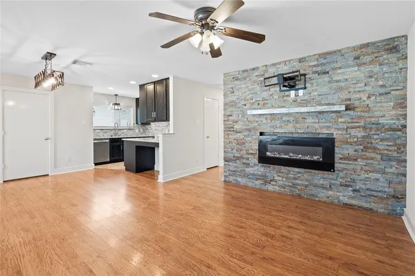 a view of kitchen and fireplace with wooden floor