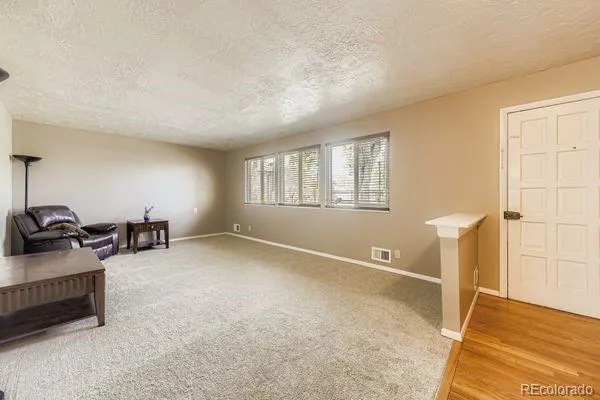 a view of a livingroom with a computer on the desk and chair