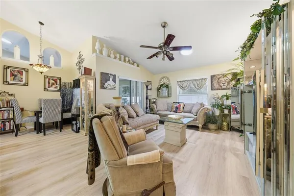 a living room with furniture and a book shelf
