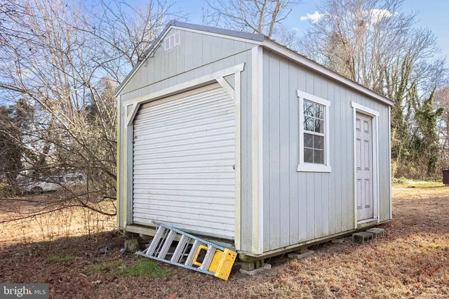 a view of a house with a yard and wooden fence