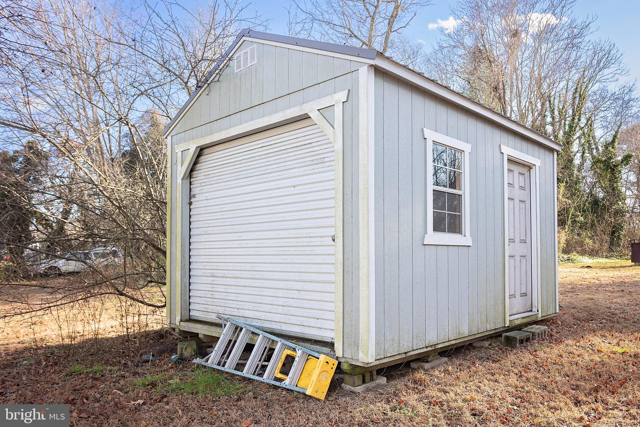 128 South Street Secretary, MD 21664 - Photo 14 of 14 a view of a house with a yard and wooden fence