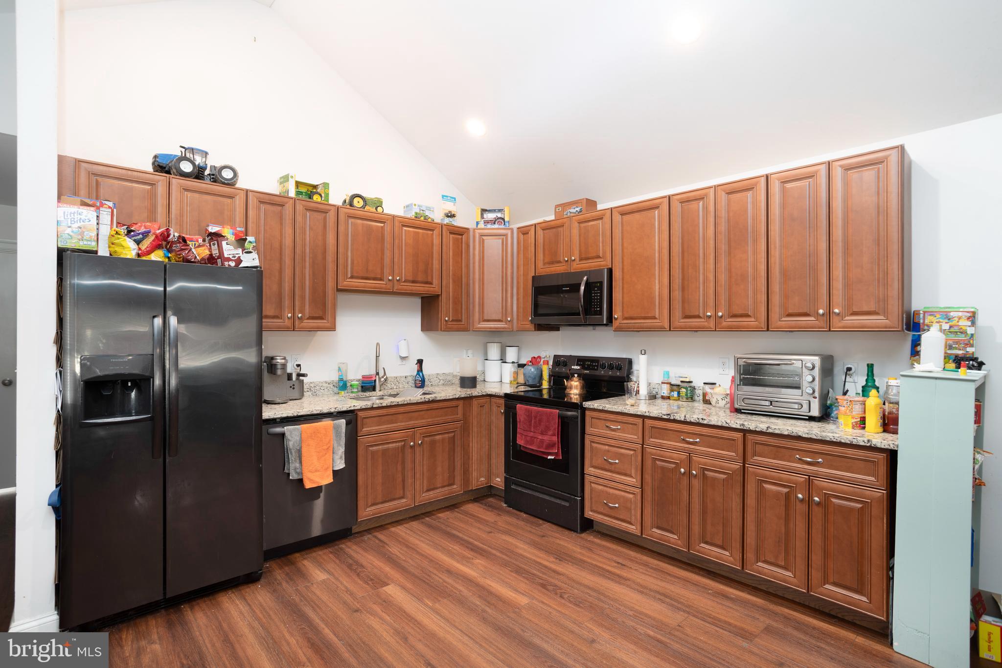 128 South Street Secretary, MD 21664 - Photo 5 of 14 a kitchen with stainless steel appliances granite countertop a refrigerator a stove top oven a sink and dishwasher