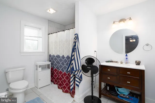 a bathroom with a sink toilet and mirror