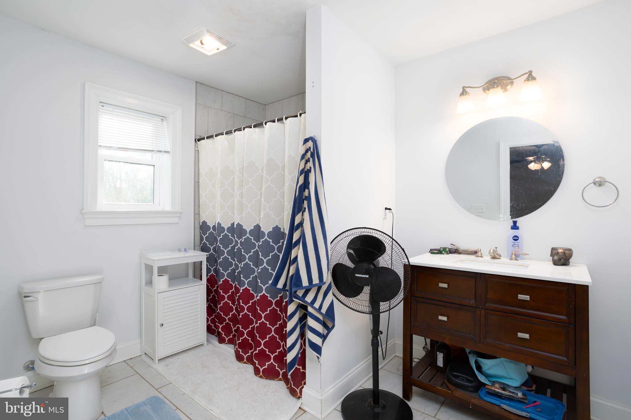 128 South Street Secretary, MD 21664 - Photo 7 of 14 a bathroom with a sink toilet and mirror