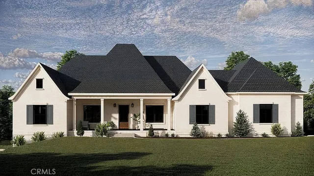 a front view of house with yard space and lake view in back