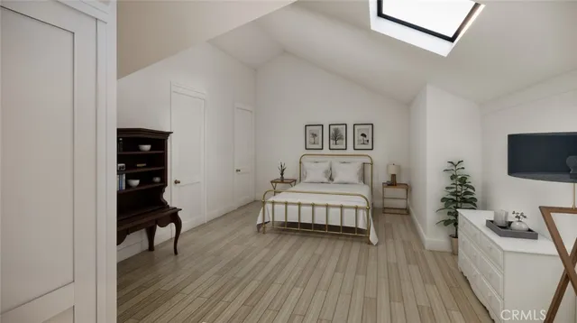 a bedroom with a bed and a chair with the wooden floor