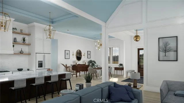 a living room with furniture kitchen view and a chandelier