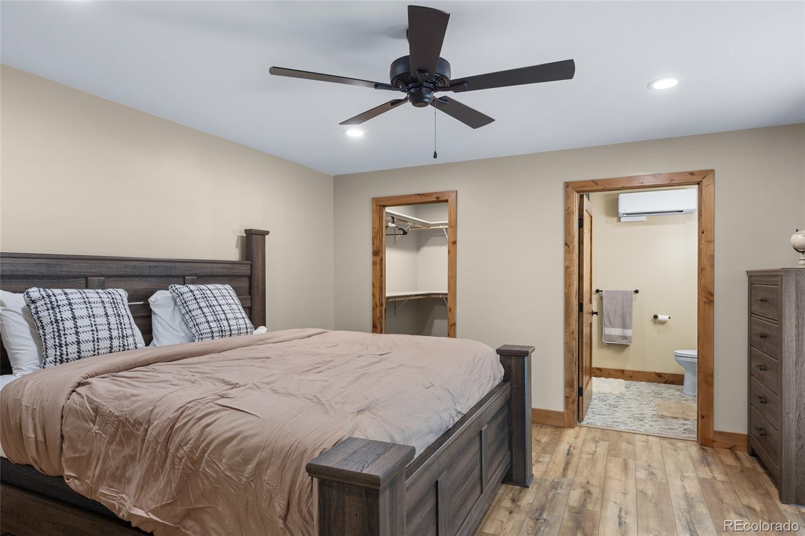 31980 Highway 24 Simla, CO 80835 - Photo 16 of 20 a bedroom with a large bed and a chandelier