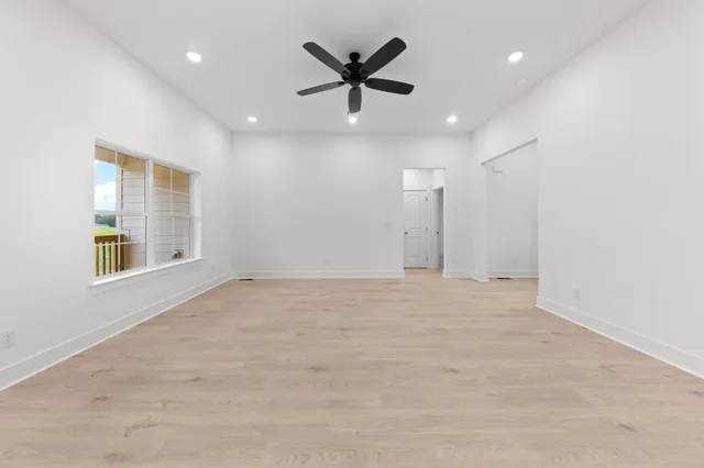 a kitchen with stainless steel appliances granite countertop a sink a stove and a wooden floors