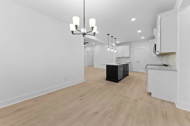 a spacious bathroom with a granite countertop sink a mirror and a