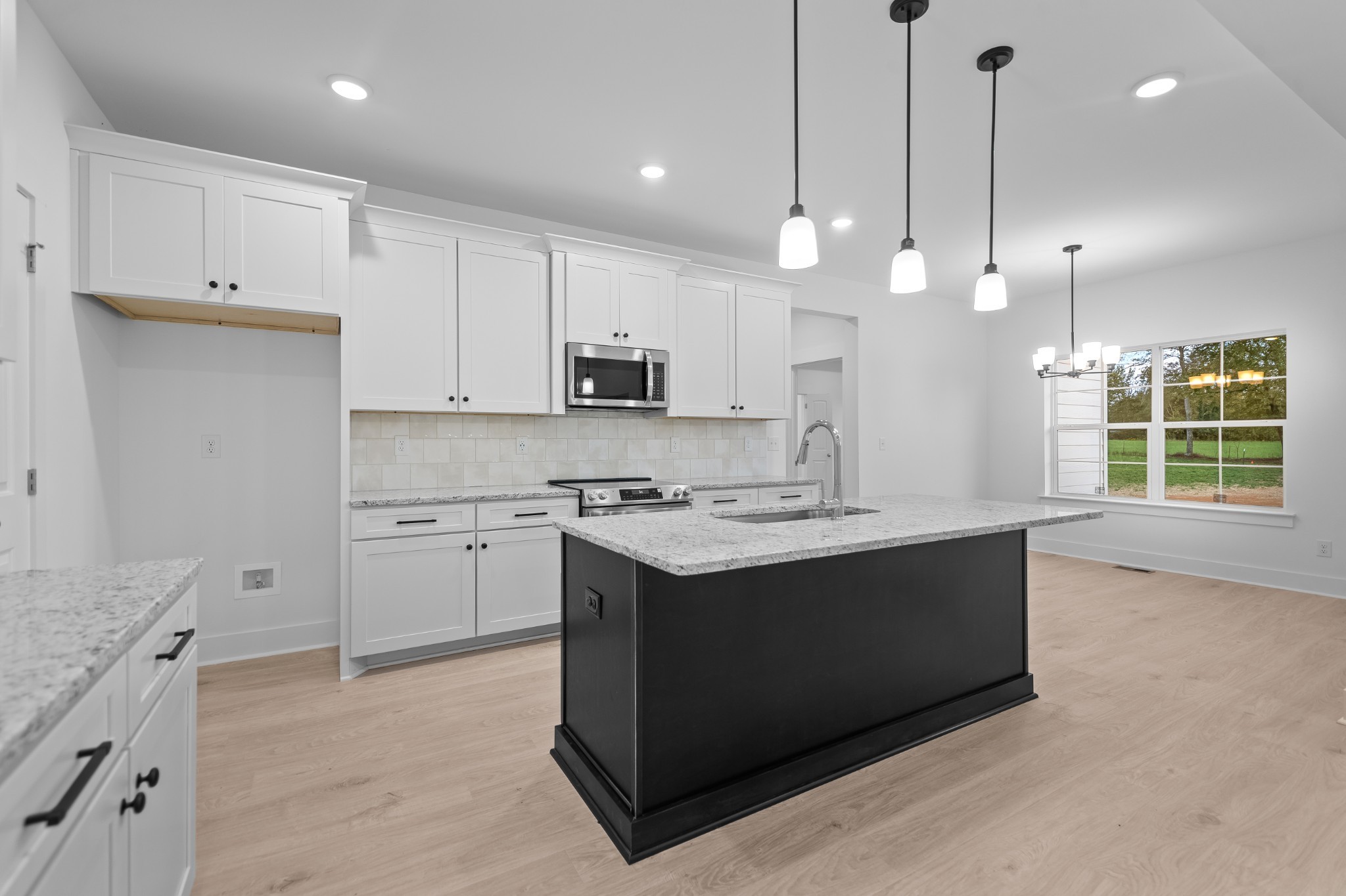 232 Dugout Road Summertown, TN 38483 - Photo 37 of 70 a kitchen with kitchen island a sink stainless steel appliances and cabinets