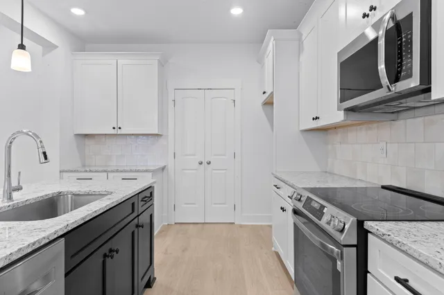 a bathroom with a granite countertop sink mirror and