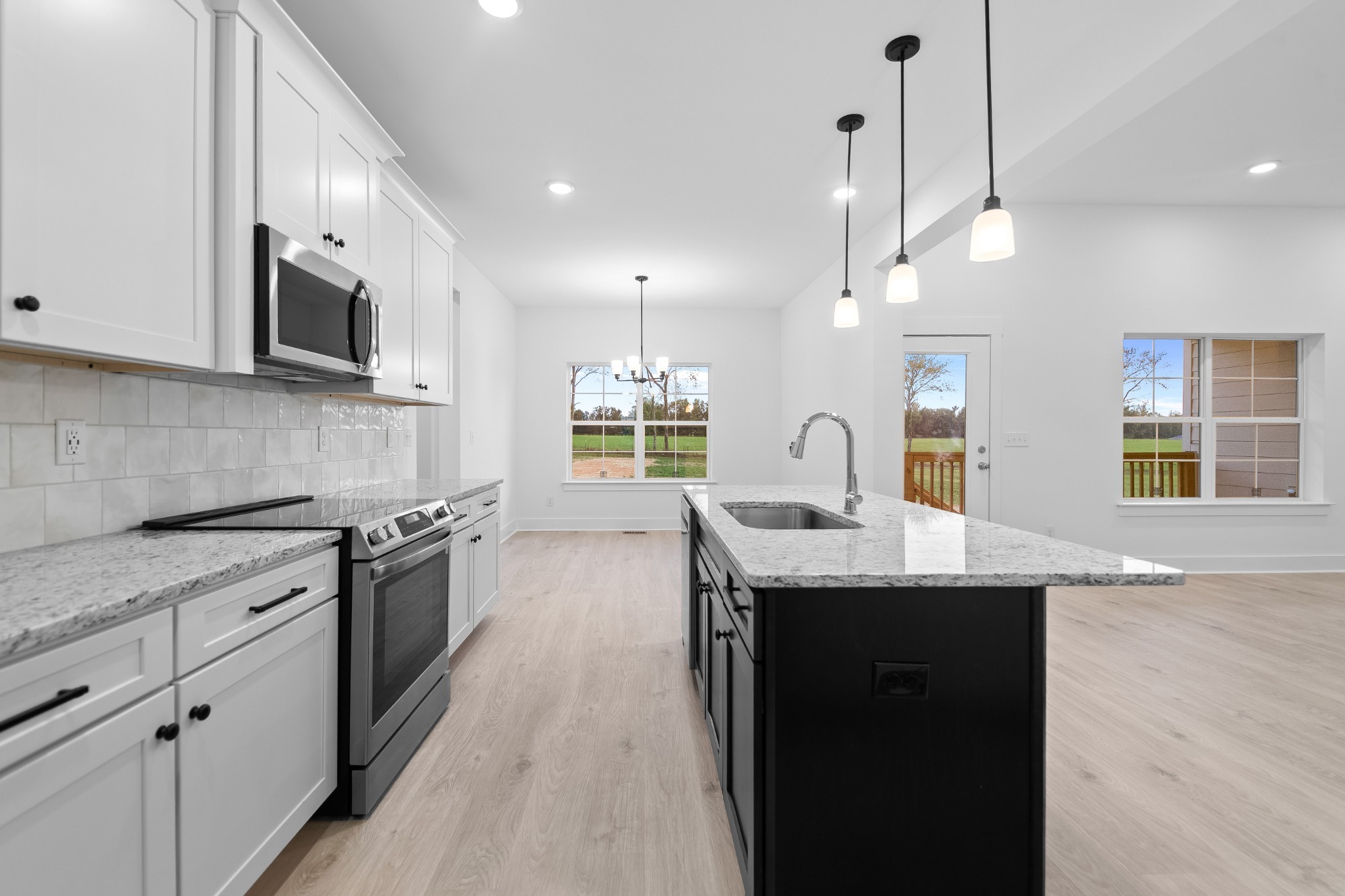 232 Dugout Road Summertown, TN 38483 - Photo 47 of 70 a kitchen with stainless steel appliances granite countertop a sink a stove and a wooden floors