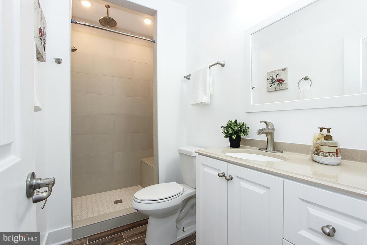 222 20th Street Northeast, Unit 1 Washington, DC 20002 - Photo 14 of 22 a bathroom with a sink a toilet and shower