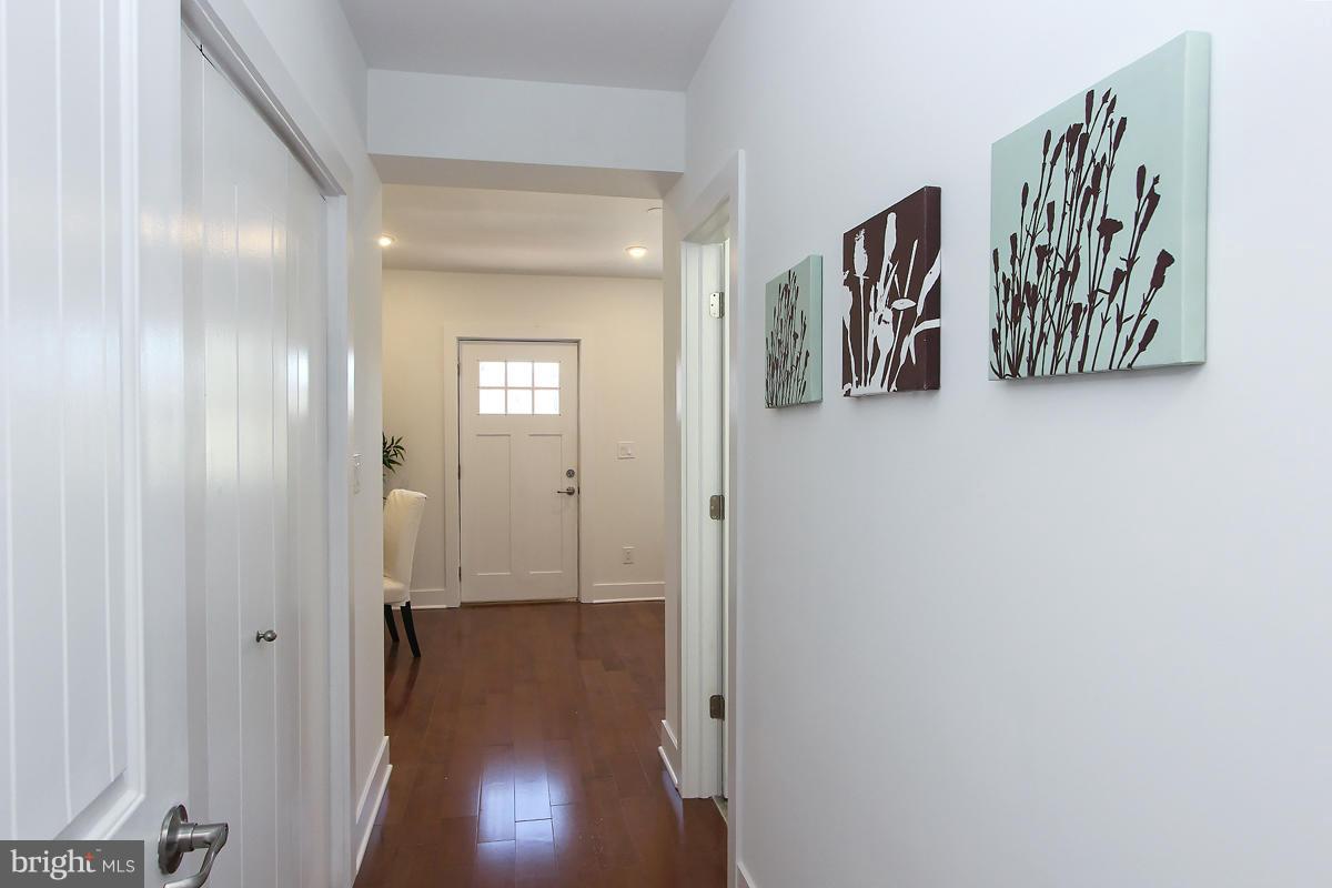 222 20th Street Northeast, Unit 1 Washington, DC 20002 - Photo 15 of 22 a view of a hallway with paintings on the wall