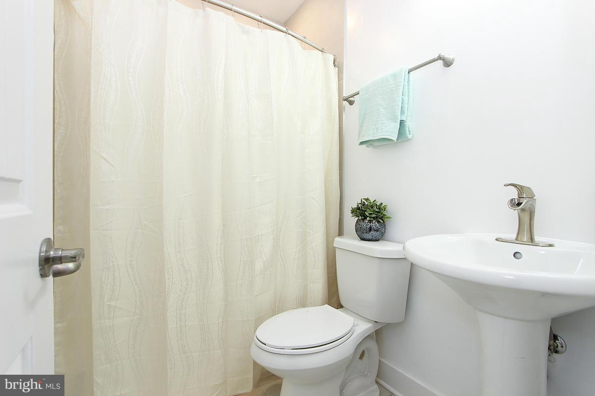 222 20th Street Northeast, Unit 1 Washington, DC 20002 - Photo 18 of 22 a bathroom with a sink a toilet and a mirror