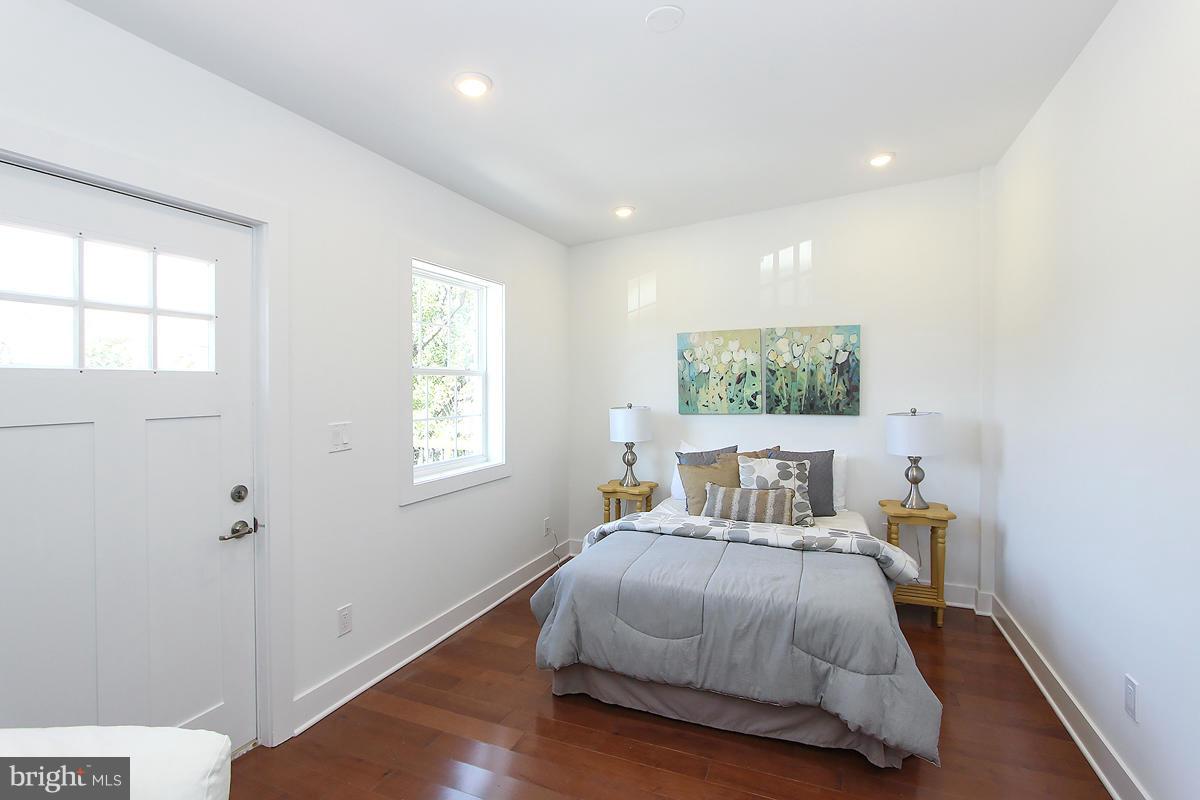 222 20th Street Northeast, Unit 1 Washington, DC 20002 - Photo 9 of 22 a bedroom with a bed and wooden floor
