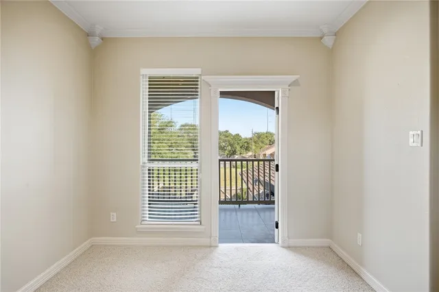 a view of a livingroom with a ceiling fan and entryway