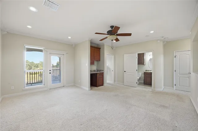 a view of a kitchen with a sink stove refrigerator and cabinets