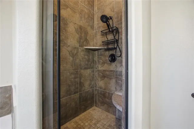 a spacious bathroom with a tub sink and mirror