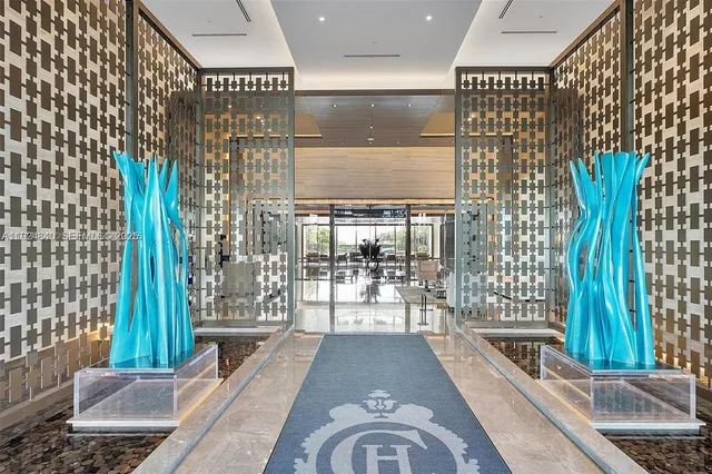 a living room with furniture and large windows