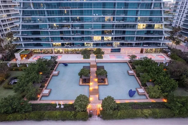 a very nice looking living room with a large window and dining table
