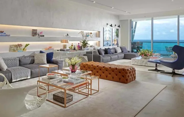 a living room with furniture and large windows