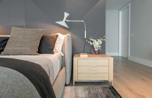 a bedroom with two beds and a flat screen tv