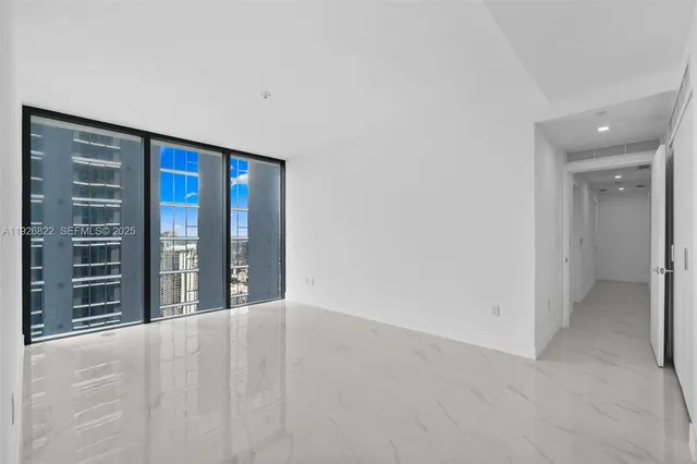 a kitchen with stainless steel appliances granite countertop a sink and a refrigerator
