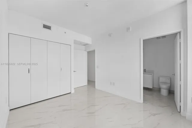 a living room with furniture and potted plants