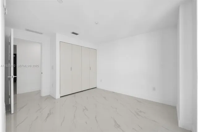 a front view of a residential apartment building with a yard