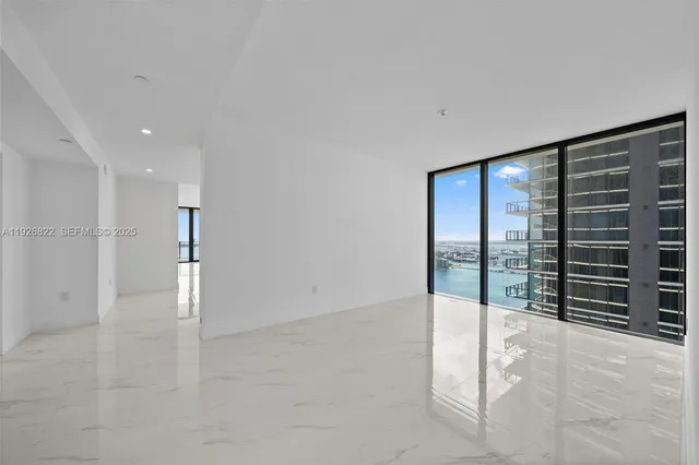 a kitchen with stainless steel appliances a sink and a refrigerator