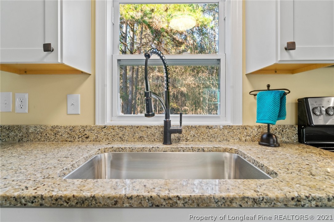 1650 Yellow Skin Road Autryville, NC 28318 - Photo 14 of 32 a view of a kitchen counter top a sink and a window
