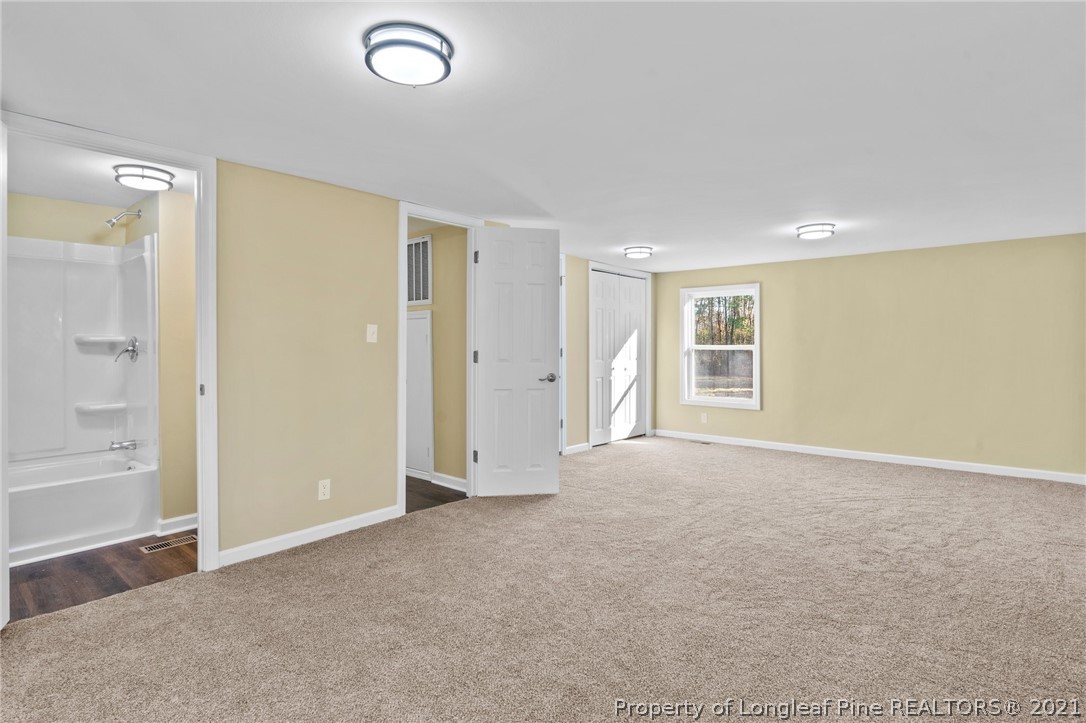 1650 Yellow Skin Road Autryville, NC 28318 - Photo 20 of 32 an empty room with windows and closet