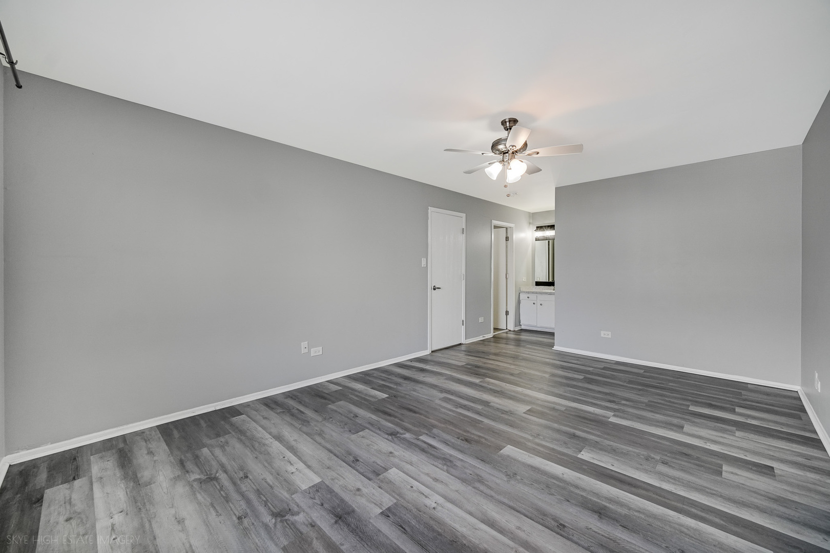 103 Red Barn Road, Unit 103 Matteson, IL 60443 - Photo 13 of 17 wooden floor in an empty room with a chandelier fan