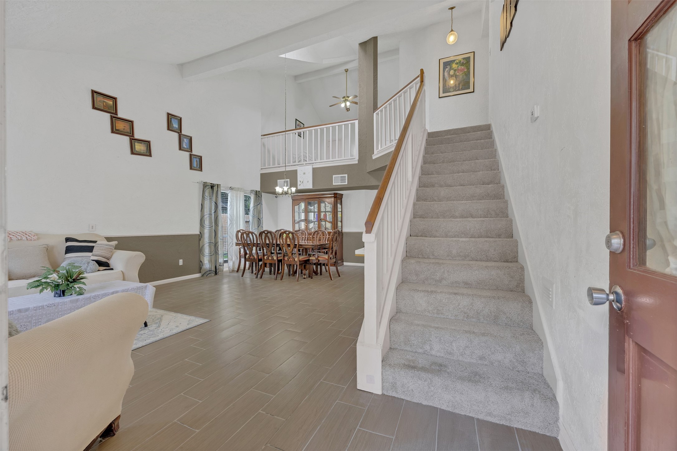 15619 Beechnut Street Houston, TX 77083 - Photo 3 of 29 Step inside to soaring ceilings and an open layout that fills the home with natural light.