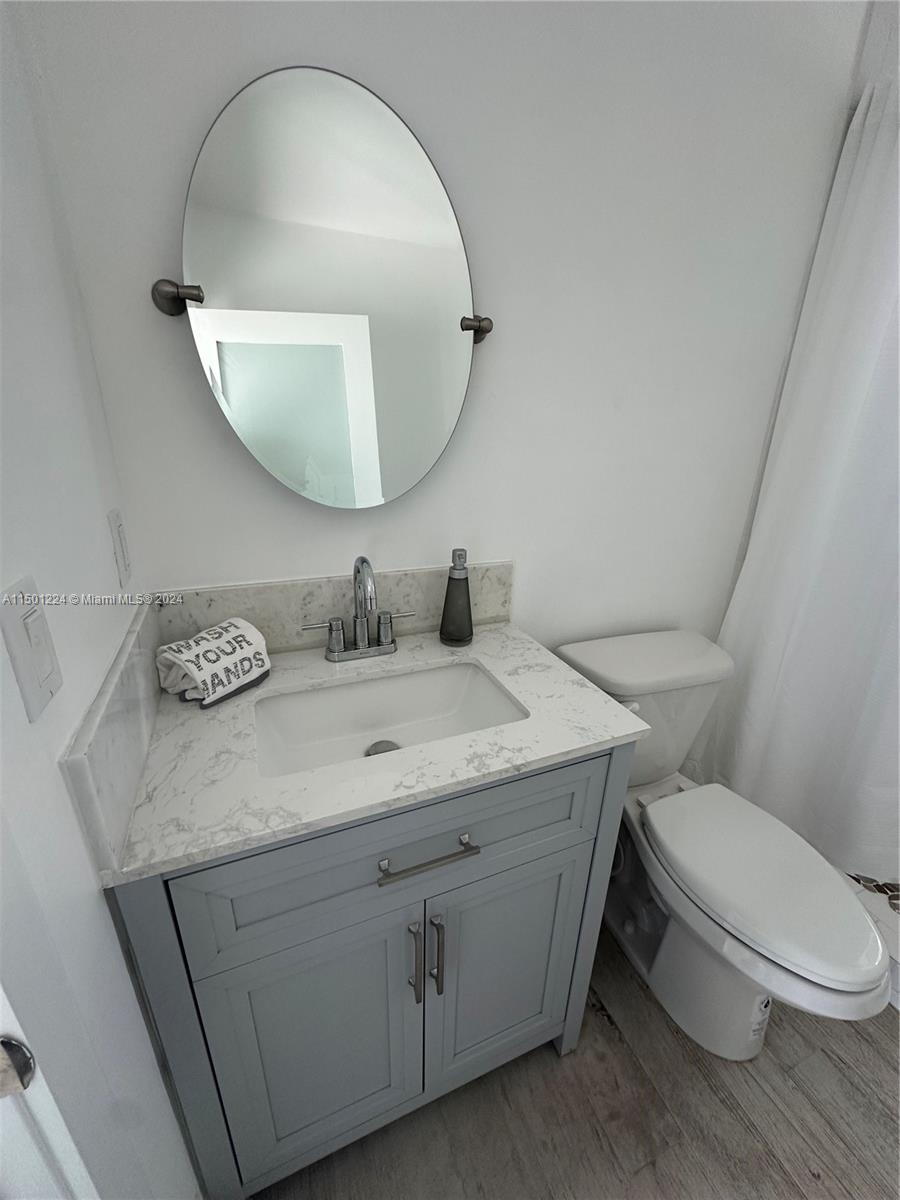 11326 5th Avenue Ocean Marathon, FL 33050 - Photo 11 of 27 a bathroom with a granite countertop toilet sink and mirror