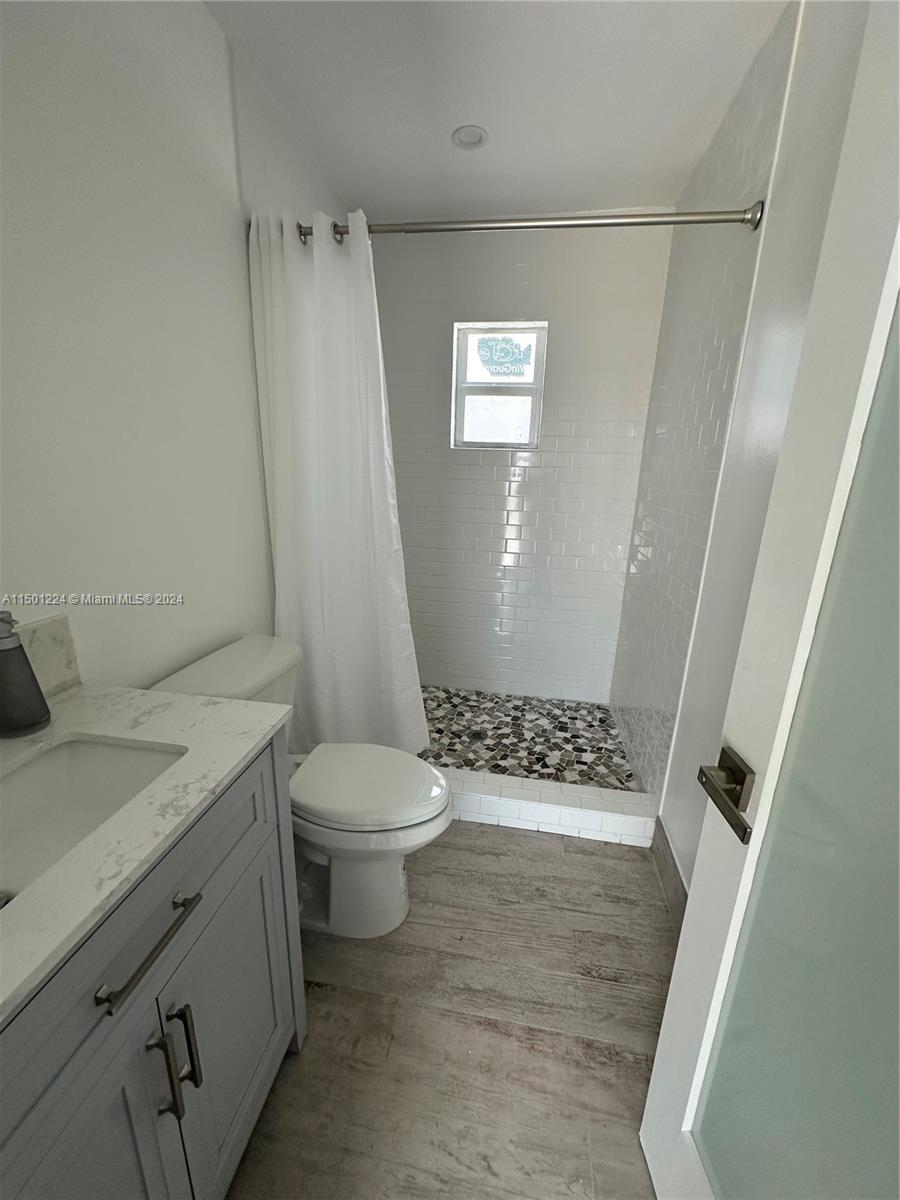 11326 5th Avenue Ocean Marathon, FL 33050 - Photo 12 of 27 a bathroom with a granite countertop sink toilet and shower