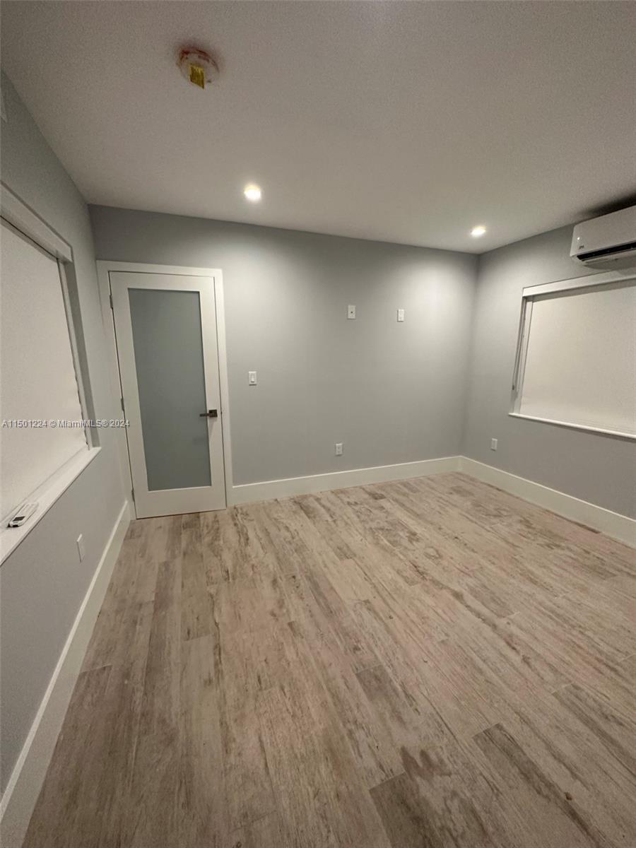 11326 5th Avenue Ocean Marathon, FL 33050 - Photo 16 of 27 an empty room with wooden floor and windows