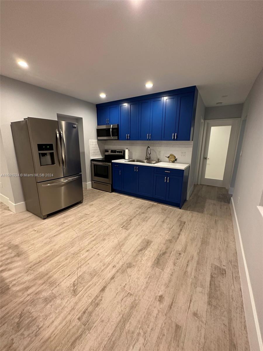 11326 5th Avenue Ocean Marathon, FL 33050 - Photo 8 of 27 a large kitchen with kitchen island granite countertop a wooden cabinets and stainless steel appliances