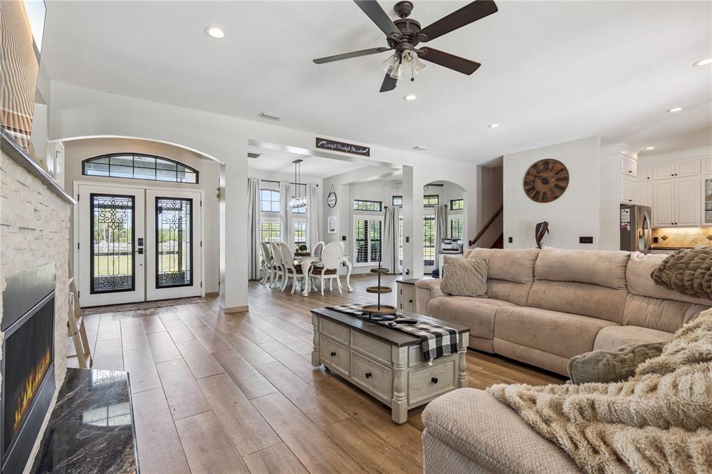 345 Cypress Isles Road Osteen, FL 32764 - Photo 3 of 41 a living room with furniture and a wooden floor