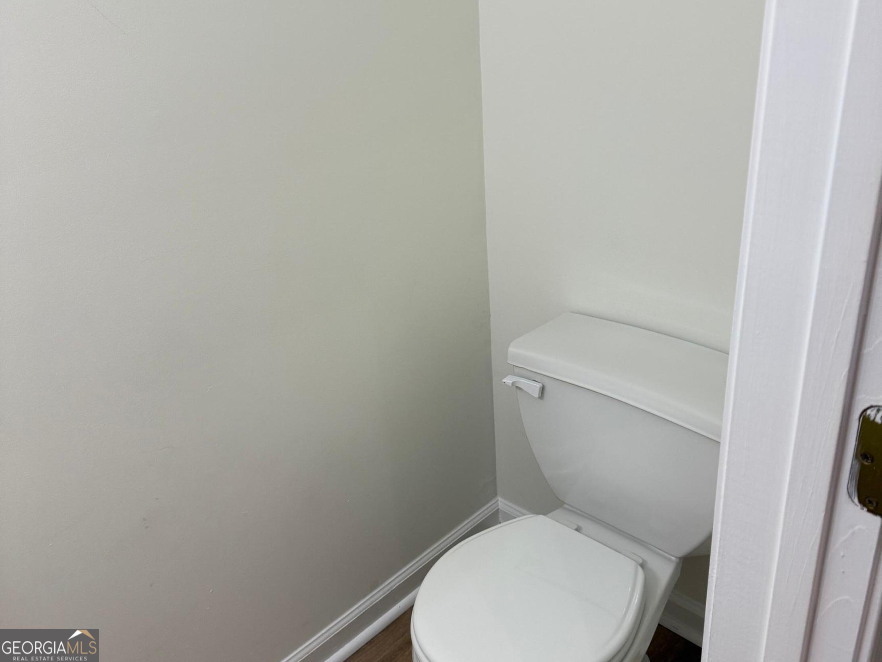 5471 Walnut Lane Lithonia, GA 30038 - Photo 16 of 40 a white toilet sitting next to a white cabinet