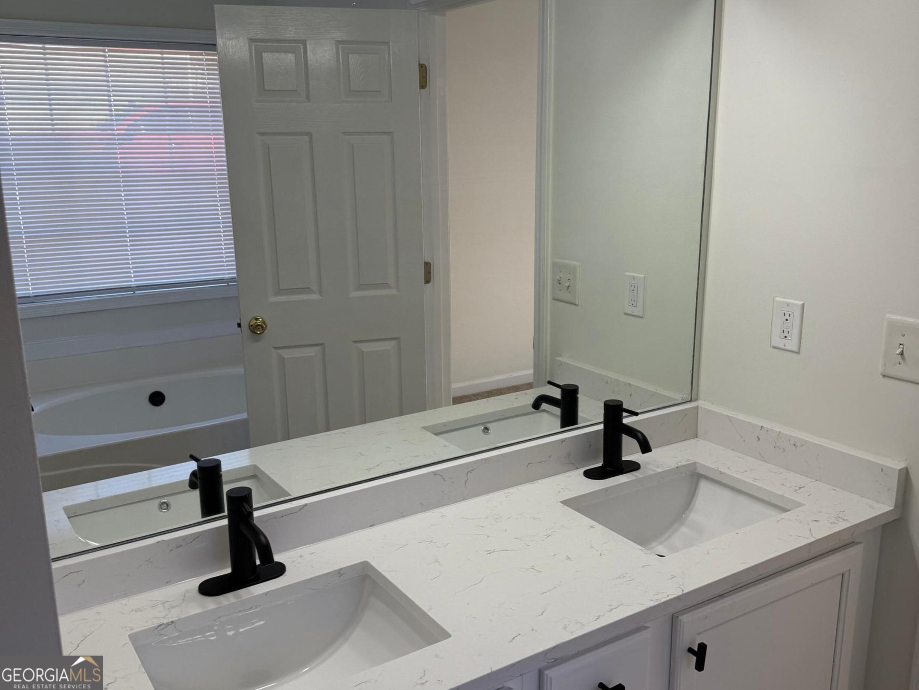 5471 Walnut Lane Lithonia, GA 30038 - Photo 20 of 40 a bathroom with a sink and a mirror