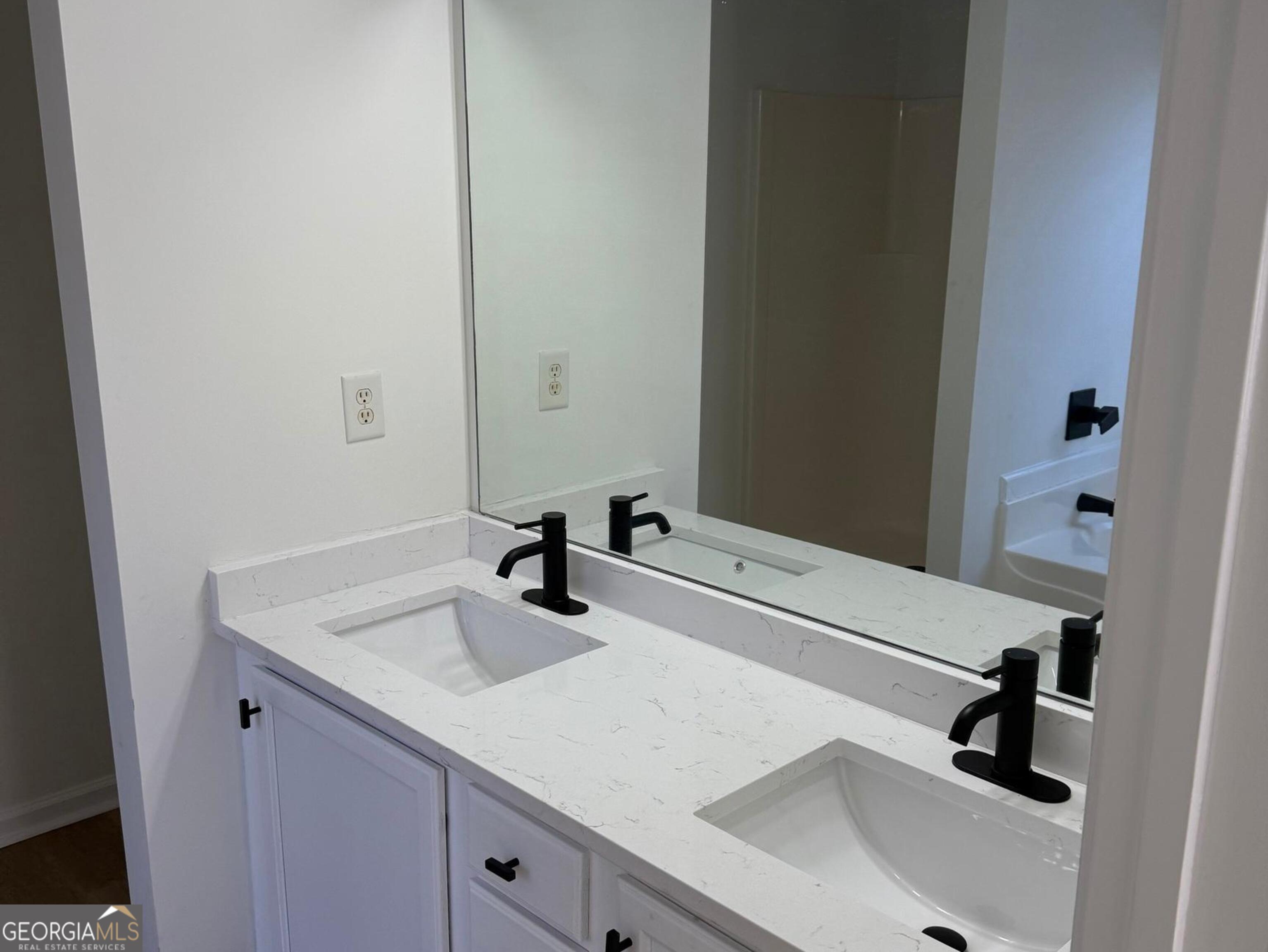5471 Walnut Lane Lithonia, GA 30038 - Photo 24 of 40 a bathroom with a sink and a mirror