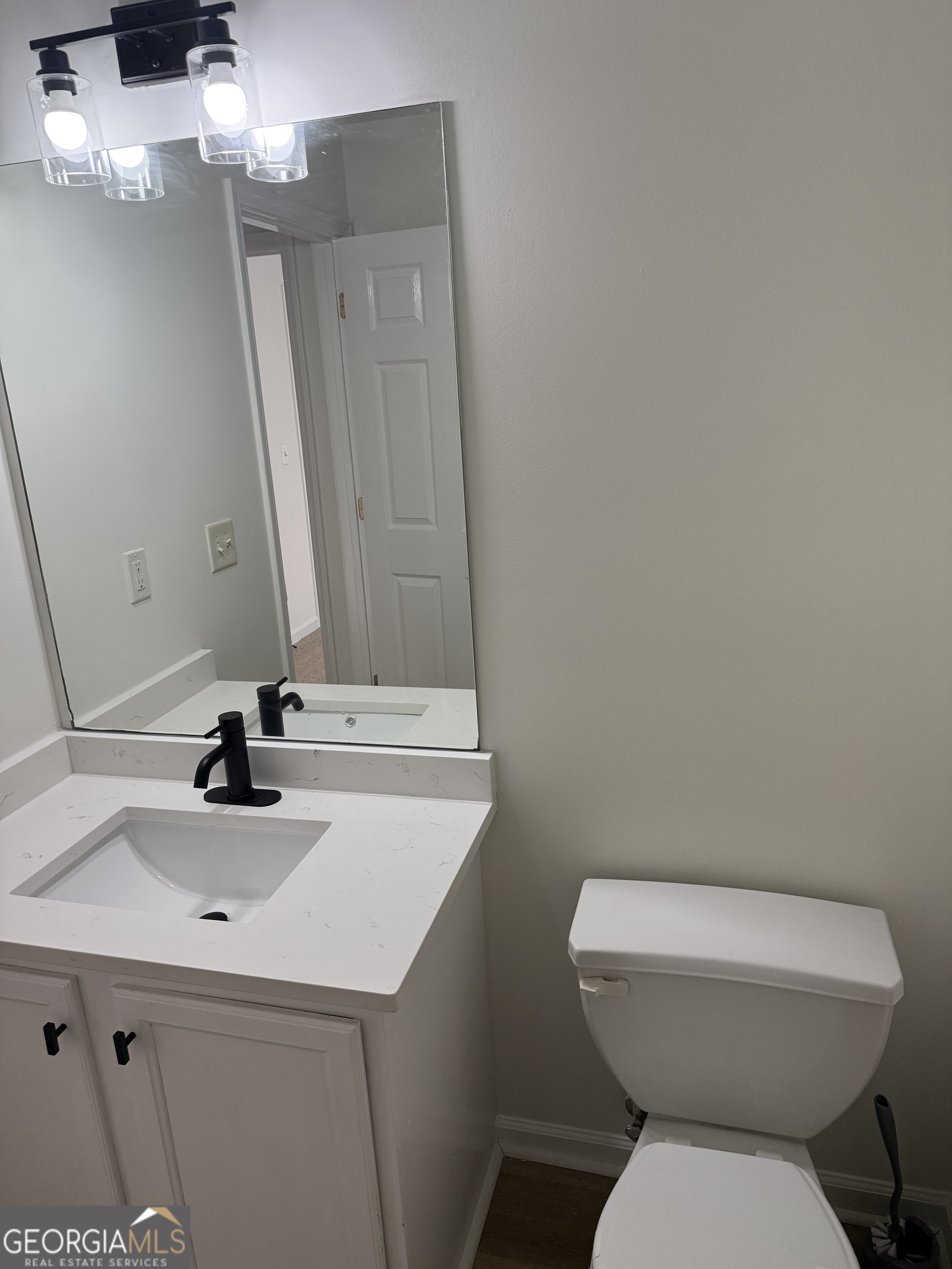 5471 Walnut Lane Lithonia, GA 30038 - Photo 31 of 40 a bathroom with a sink a toilet and mirror