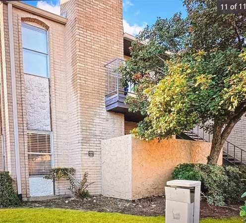 a brick house with a tree in front of it